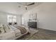 Bright main bedroom featuring a ceiling fan, a window, modern art and decor, and wood-look floors at 3834 E Clarendon Ave, Phoenix, AZ 85018
