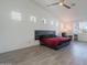 Spacious main bedroom features a vaulted ceiling, modern ceiling fan, and comfortable seating area at 3834 E Clarendon Ave, Phoenix, AZ 85018