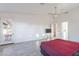 Large main bedroom featuring tiled floors, a ceiling fan, and access to the en-suite bathroom at 3834 E Clarendon Ave, Phoenix, AZ 85018