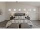 Inviting primary bedroom featuring a vaulted ceiling, cozy seating area, and wood-look floors at 3834 E Clarendon Ave, Phoenix, AZ 85018
