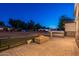 Inviting outdoor patio area with fire pit, modern fencing, and lush green lawn at 3834 E Clarendon Ave, Phoenix, AZ 85018
