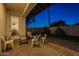 Cozy outdoor patio area with seating, lush landscaping, and inviting doorway to the home at 3834 E Clarendon Ave, Phoenix, AZ 85018