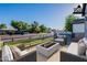 Virtually staged outdoor patio area with modern seating and a cozy fire pit at 3834 E Clarendon Ave, Phoenix, AZ 85018
