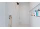 Bright, white tiled shower featuring a niche for toiletries and modern fixtures at 3834 E Clarendon Ave, Phoenix, AZ 85018