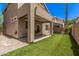 Backyard view showcasing patio, artificial grass, and desert landscaping at 4117 E Baylor Ln, Gilbert, AZ 85296