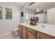 Bathroom featuring double sinks, and decorative wood organizer, vanity and large mirror at 4117 E Baylor Ln, Gilbert, AZ 85296