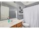 Well-lit bathroom featuring a wooden vanity, mirror, and toilet at 4117 E Baylor Ln, Gilbert, AZ 85296