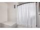 Bathroom features a white shower tub combination with white shower curtain and neutral walls at 4117 E Baylor Ln, Gilbert, AZ 85296
