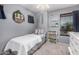 Inviting bedroom showcasing a well-lit space with shelves and large window at 4117 E Baylor Ln, Gilbert, AZ 85296