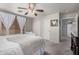Neutral bedroom features a ceiling fan, carpet, and windows dressed with sheer white curtains at 4117 E Baylor Ln, Gilbert, AZ 85296