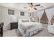 Neutral bedroom features a ceiling fan, carpet, and windows dressed with wood blinds at 4117 E Baylor Ln, Gilbert, AZ 85296