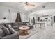 Bright living room with open access to a kitchen and dining area, featuring tiled floors and modern décor at 4117 E Baylor Ln, Gilbert, AZ 85296