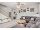 Inviting living room with a gray sectional sofa, wood coffee table, and neutral decor with tiled floors at 4117 E Baylor Ln, Gilbert, AZ 85296
