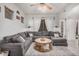 Inviting living room with a gray sectional sofa, wood coffee table, and neutral decor with tiled floors at 4117 E Baylor Ln, Gilbert, AZ 85296