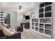 Comfortable living room featuring ample seating, shelving, and a ceiling fan at 4117 E Baylor Ln, Gilbert, AZ 85296