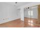 Spacious bedroom with wood floors, sliding closet and natural light from the window at 4200 N Miller Rd # 112, Scottsdale, AZ 85251