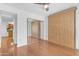 Bedroom featuring wood floors, mirrored closet, and natural light from the window at 4200 N Miller Rd # 112, Scottsdale, AZ 85251