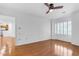 Bedroom view features wood floors, ceiling fan, and window with shutters at 4200 N Miller Rd # 112, Scottsdale, AZ 85251