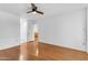 Bedroom with wood floors, ceiling fan, and views of en-suite at 4200 N Miller Rd # 112, Scottsdale, AZ 85251