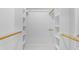 Walk in closet with white shelving and clothing rods ready for organizing at 4200 N Miller Rd # 112, Scottsdale, AZ 85251