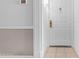 Close-up of white entry door with tiled floor and elegant decorative hardware at 4200 N Miller Rd # 112, Scottsdale, AZ 85251