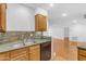 Oak cabinets, granite countertops and stainless-steel dishwasher in this well-equipped kitchen at 4200 N Miller Rd # 112, Scottsdale, AZ 85251