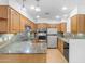 Spacious kitchen features tile backsplash, stainless steel appliances, and plenty of counter space at 4200 N Miller Rd # 112, Scottsdale, AZ 85251