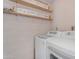 Bright laundry room featuring new washer and dryer and built-in shelving for organized storage of supplies at 4200 N Miller Rd # 112, Scottsdale, AZ 85251