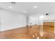 Large living room features wood floors, base cabinets, and recessed lighting at 4200 N Miller Rd # 112, Scottsdale, AZ 85251