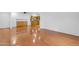 Bright living room features wood floors, base cabinets, and view of kitchen area at 4200 N Miller Rd # 112, Scottsdale, AZ 85251