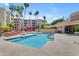 Resort-style pool area with comfortable lounge chairs, lush palm trees, and a refreshing pool for relaxation at 4200 N Miller Rd # 112, Scottsdale, AZ 85251