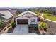 Expansive aerial view of a well-maintained home with a tile roof, landscaped yard, and walking path at 4352 N 91St Gln, Phoenix, AZ 85037
