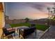 An alluring backyard with artificial grass, ambient lighting, and a modern patio set at 4352 N 91St Gln, Phoenix, AZ 85037