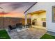 Inviting backyard with BBQ and seating adjacent to artificial grass and paved patio at 4352 N 91St Gln, Phoenix, AZ 85037