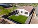 Aerial view of a backyard with synthetic grass, patio with seating and grill at 4352 N 91St Gln, Phoenix, AZ 85037