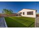 Backyard with artificial grass, block wall and covered patio of a new home at 4352 N 91St Gln, Phoenix, AZ 85037