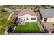 A backyard with synthetic grass and patio with outdoor seating at 4352 N 91St Gln, Phoenix, AZ 85037