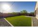 Well-manicured backyard featuring artificial grass and a cozy seating area at 4352 N 91St Gln, Phoenix, AZ 85037