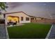 Backyard featuring green artificial grass, BBQ grill and outdoor seating at 4352 N 91St Gln, Phoenix, AZ 85037