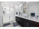 Modern bathroom featuring a walk-in shower with a glass door and double sink vanity at 4352 N 91St Gln, Phoenix, AZ 85037