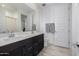 Bathroom featuring a double sink vanity with dark wood cabinets and white quartz countertops at 4352 N 91St Gln, Phoenix, AZ 85037