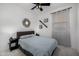 Cozy bedroom featuring neutral colors, ceiling fan, and unique decor at 4352 N 91St Gln, Phoenix, AZ 85037