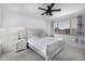 Bright bedroom featuring a white bed, ceiling fan, neutral walls, and soft carpet at 4352 N 91St Gln, Phoenix, AZ 85037