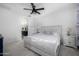 Bright bedroom with a white bed, ceiling fan, and ensuite bathroom at 4352 N 91St Gln, Phoenix, AZ 85037