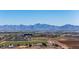 Expansive cityscape view of a city, farms, and mountain range in the background at 4352 N 91St Gln, Phoenix, AZ 85037