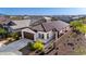 Charming single-story home with a well-manicured lawn, brown tile roof, and two-car garage at 4352 N 91St Gln, Phoenix, AZ 85037