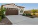 Stunning home exterior featuring a tile roof, a two-car garage, and a well-manicured lawn at 4352 N 91St Gln, Phoenix, AZ 85037