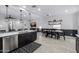 Open concept kitchen with stainless steel appliances and seating area flowing into the living room at 4352 N 91St Gln, Phoenix, AZ 85037
