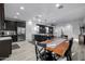 Open concept kitchen flows into living room, with dark cabinets and stainless steel appliances at 4352 N 91St Gln, Phoenix, AZ 85037