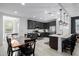 Eat-in kitchen featuring dark cabinetry, stainless steel appliances, island with seating, and hardwood floors at 4352 N 91St Gln, Phoenix, AZ 85037